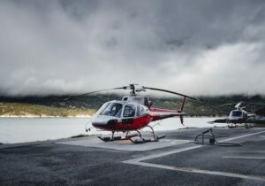a red and blue helicoper departing in antigua 