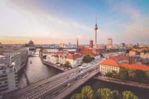 City buildings in daytime near water and a bridge in Berlin, Germany - remote working cities in Europe