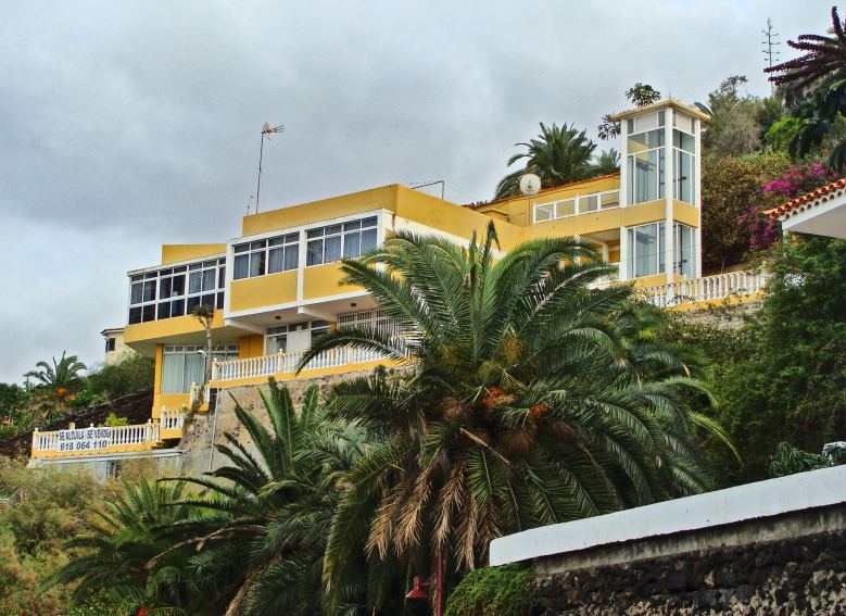 yellow caribbean home on a mountain side in dominica