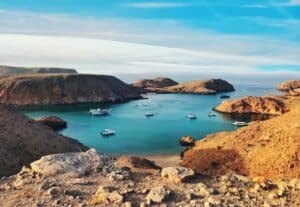 View of ocean from light brown mountain tops in Oman - zero tax countries