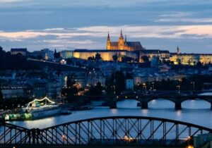 Bridge in Czech Republic with city lights in the background - countries in Europe for foreigners to move to