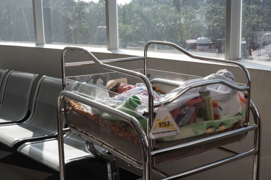 Baby in a crib in hospital by a window - Countries With Birthright Citizenship
