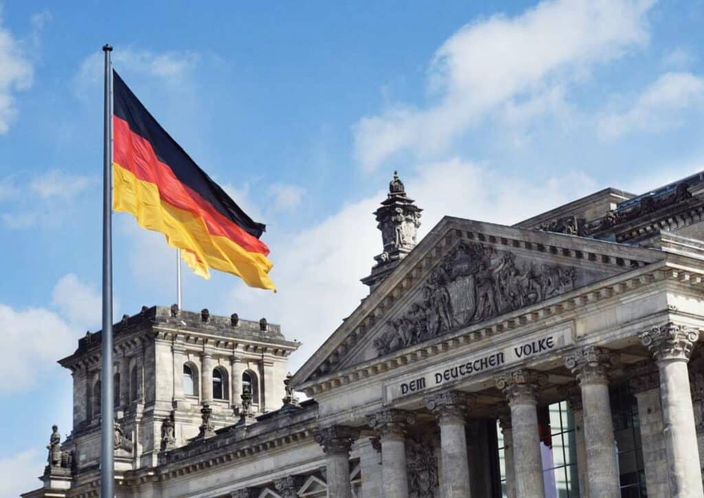 German flag waving in front of a government building in Germany - where to live as an expat