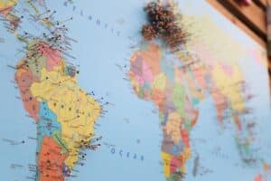 Map of Americas and Europe with colorful pins inserted - birthright citizenship types