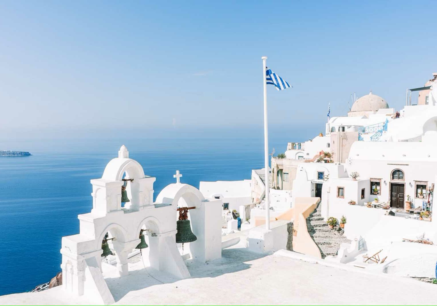 Traditional white Greek buildings overlooking the ocean in Oia, Greece - Greek citizenship by investment