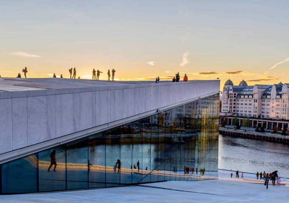People walking on and around the beautiful opera house in Oslo, Norway - best countries to live in 