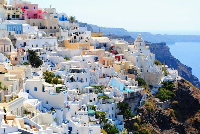 White houses in Greece, along the ocean shoreline - Get a Golden Visa Bank Account