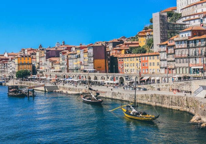 Colorful buildings lining a harbor in Portugal - best countries to live in around the world