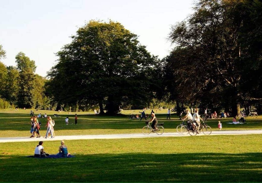 People walking and biking in green park - Richest country in the world by social progress indicators