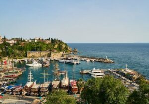 Shoreline of Turkey on a sunny day with boats moored - Understanding country of residence
