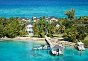 Aerial view of a dock to a mansion in the Cayman Islands surrounded by palm trees - countries with no income tax