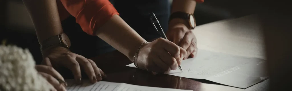 person signing documents for the cultural golden visa application process