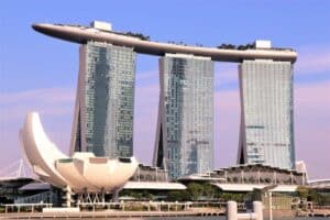 Close-up of iconic Marina Bay Sands Resort in Singapore with a purple and blue skies in the background - how international real estate investment