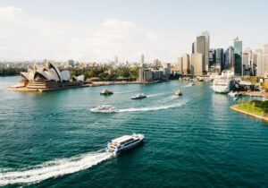 Boat speeding on the ocean next to the Sydney Opera House - Australia for investors