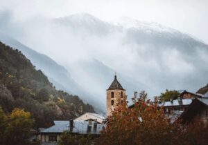 Cloudy view of houses and mountain in Andorra - low-tax haven for EU expats