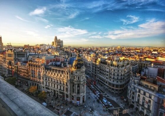 Aerial view of Spanish buildings under a clear blue sky.