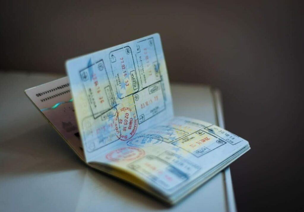 Open passport with stamps lying on a desk - dual citizenship tax policies