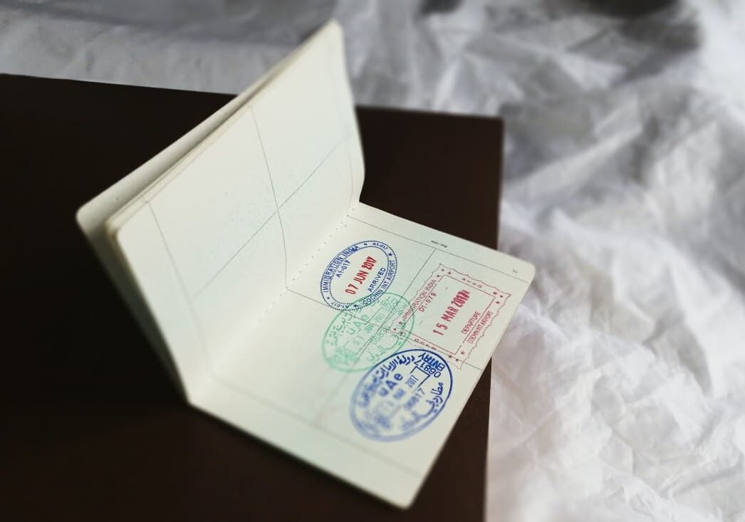 Passport laying open showcasing stamps on a side table - citizenship via naturalization