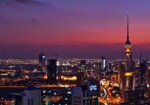 City in Kuwait lit up at night - oil-rich country with no taxes on real estate