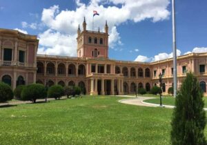 Vintage brick building with a square tower in the middle of an urban park in Paraguay - residency by investment program in Paraguay