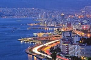 Night view of Izmir, Turkey, with city lights reflecting on the sea