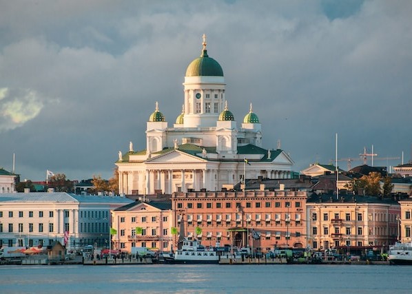 Iconic Nicolas Church's green dome sticking out over buildings in Finland - safe country in Europe