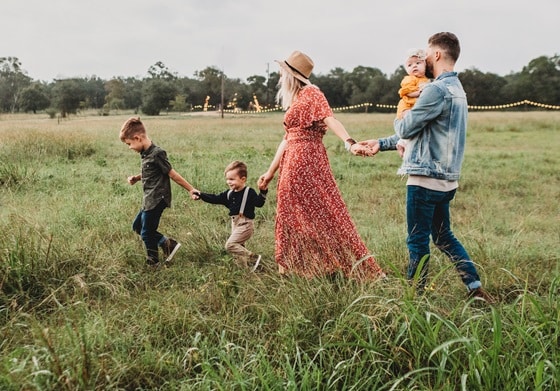 family of four walking in a park