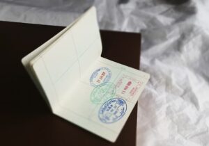 Passport laid open on side table with white linen in background - ancestral citizenship