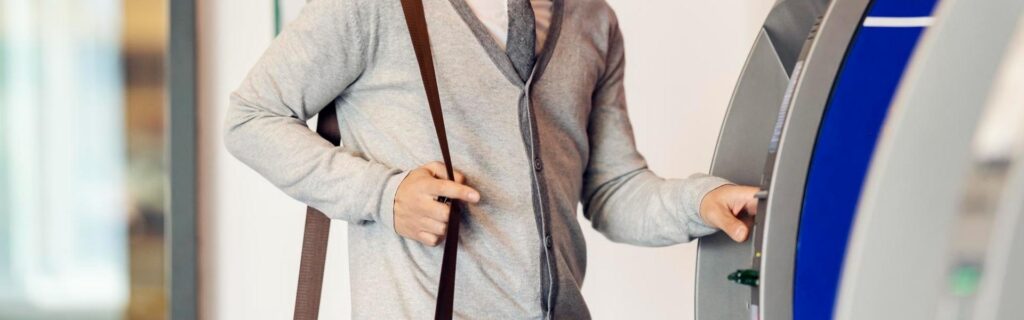 person withdrawing cash from an atm in grenada