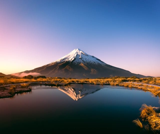 Snowcapped Mount Taranaki in New Zealand at sunset - moving out of the United States of America
