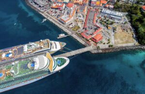 two close-loop cruise ships docked in a caribbean harbor