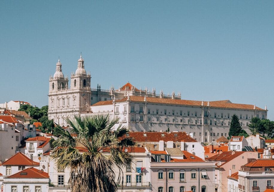 Large white and brown concrete building in Alfama in Lisbon, Portugal - easy immigration route to Portugal