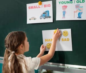 child writing on a board at school districts in Canada