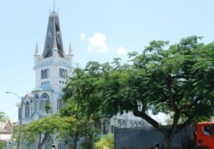 St George's Cathedral in Guyana with lush trees in the foreground - one of 10 fastest-growing world economies