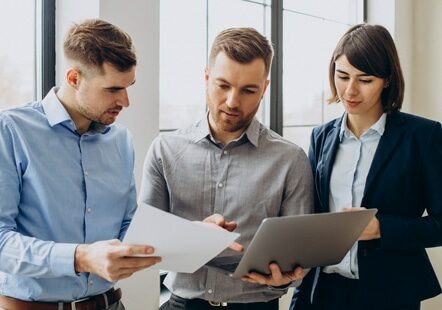 three colleagues working on documents together