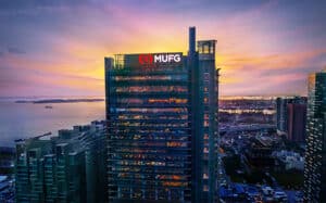 Mitsubishi UFJ Financial Group logo on the side of a skyscraper with a golden sunset in the background - best banks in the world