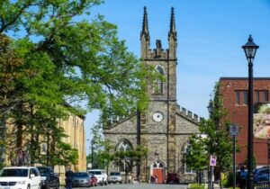 cathedral in canada with trees and cars parked