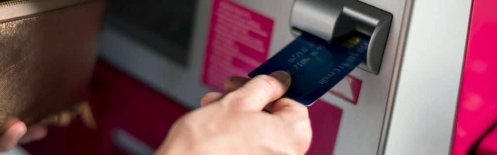 a person using a caribbean atm machine