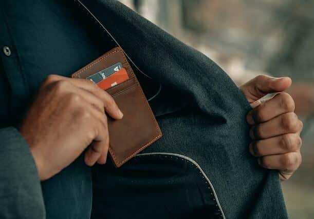 Man putting a wallet in his jacket pocket