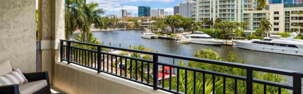 view from a balcony overlooking the water and other condos in the caribbean