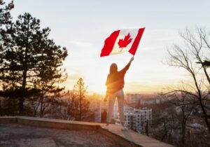 person holding a flag after getting a Canadian citizenship by descent