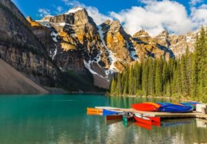 lake in Canada near a mountain surrounded by tall trees