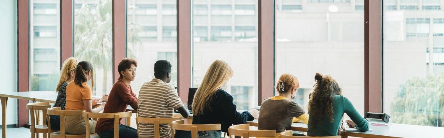 students studying by a window in a caribbean university