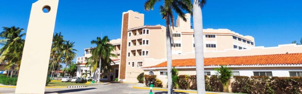 wide angle view of a university in the caribbean with a blue sky background