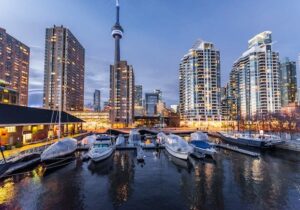 Boats moored at a harbor in Toronto, Canada with the skyline in the background - best cities to live and work