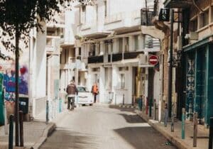 Small street in Limassol, Cyprus with a man cycling and another walking - Cyprus permanent residency
