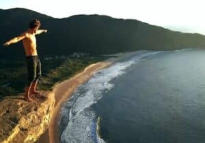 Man standing on a cliff in Florianopolis in Brazil - Brazil investor visa