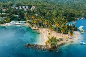 Shoreline in St Kitts and Nevis with boats moored on either side - tax benefits in cryptocurrency havens
