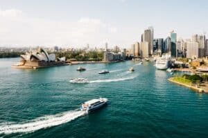 Boat speeding past the Sydney Opera House - Australian healthcare for foreigners