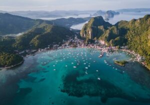 Shoreline of Philippines with mountains in the background - English-speaking countries to live in as an expat 